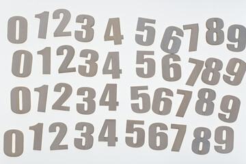 plain unpainted wood numbers arranged on a blank surface