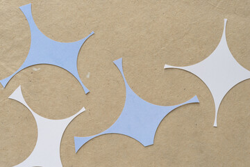 abstract paper shapes with curved edges arranged on plain brown paper