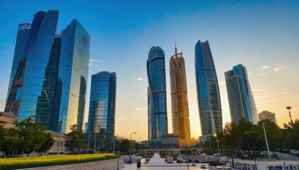 Obraz premium City Skyline: A breathtaking panorama of a modern city skyline, showcasing towering skyscrapers of glass and steel, bathed in the soft glow of dawn or dusk. The scene reflects the ambition, progress.