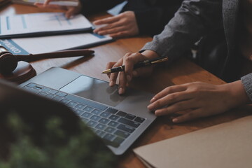 Judge gavel with Justice lawyers having team meeting at law firm background. Concepts of Law and Legal services.