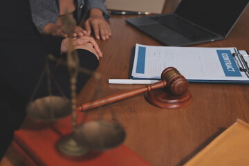 Judge gavel with Justice lawyers having team meeting at law firm background. Concepts of Law and...