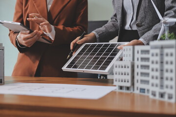 Discussion among businesspeople on the latest developments in solar cell panel technology and Solar Energy Environment city Concept.