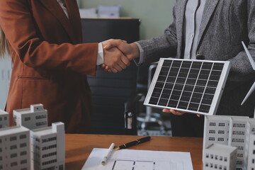 Discussion among businesspeople on the latest developments in solar cell panel technology and Solar Energy Environment city Concept.