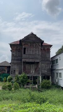 BANGKOK, THAILAND &ndash; MARCH 7, 2025: Windsor House, a 19th century old teakwood house stands majestically in the Kudi Chin area near the Chao Phraya River.