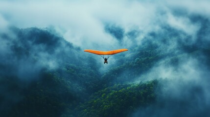 Hang Glider Soaring Above Misty Rainforest Canopy