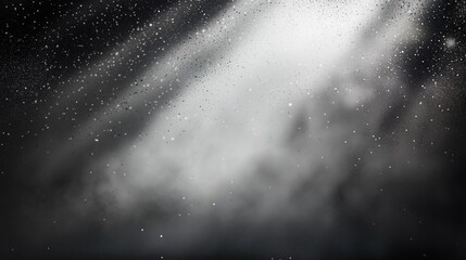 Abstract black background with white spray paint and floating dust particles illuminated by a soft glow from behind, creating a mysterious and atmospheric texture with light and shadow contrast.