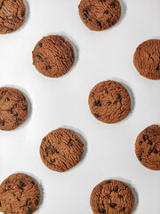 several pieces of chocolate cookies form a pattern on a white background