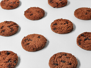 several pieces of chocolate cookies form a pattern on a white background