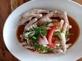 fresh chicken feet and vegetable spicy salad on plate