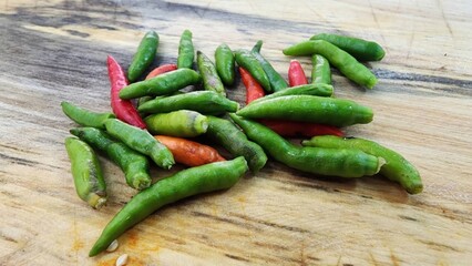 Fresh Green and Red Chili Peppers on Wooden Cutting Board