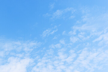 beautiful blue sky and white fluffy group of clouds with sunrise in the morning, natural background