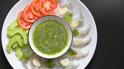 shrimp in fish sauce with Thai spicy seafood dipping sauce on white plate