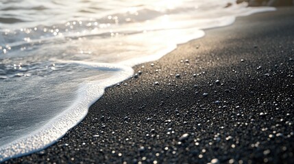 The ocean waves washing ashore on a black sand beach