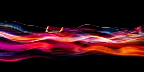 Obraz premium This vibrant abstract image captures colorful light trails in motion against a dark background, creating a sense of energy and fluidity that enhances visual appeal.
