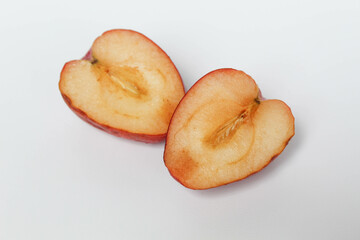 Halved strawberry apples or cherry apple, isolated on white background