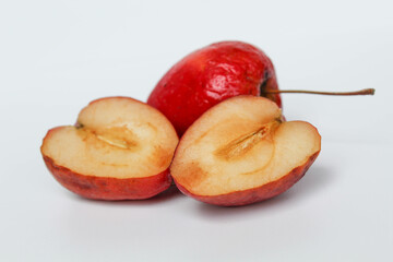 Halved strawberry apples or cherry apple, isolated on white background