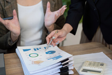 Collaborative analysis. Professionals discussing financial data and tax strategies at a desk during a meeting.