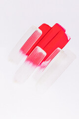 beautiful of red and silver brush strokes of acrylic paint on a white background. Abstract paint texture background. The concept of artistic design.