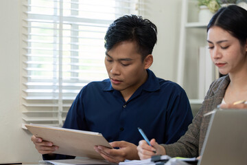 Teamwork in analysis. Tax professionals reviewing documents and strategies together in a collaborative office setting.