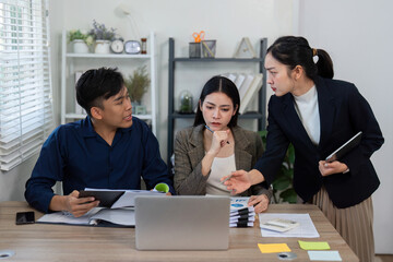 Team members discussing strategies in a modern office, emphasizing collaboration and problem-solving.