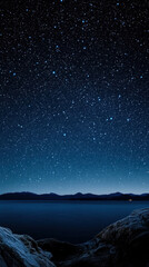 Fototapeta premium Night sky full of stars over a lake and mountains