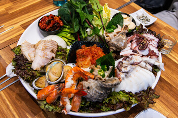 dish of various seafoods and boiled pork with vegetables