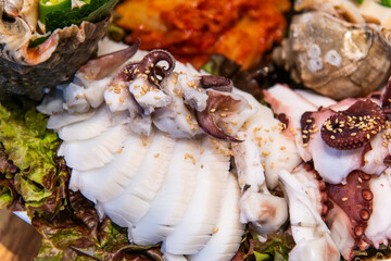 slices of boiled octopus with other foods on the dish