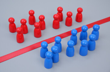 Obraz premium Blue and red people figures separated by red line on gray background.