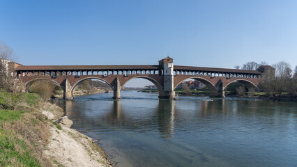 Fototapeta premium Pavia, Italy. Amazing view of the Ponte Coperto (Covered Bridge) or the Ponte Vecchio (Old Bridge) over the Ticino river