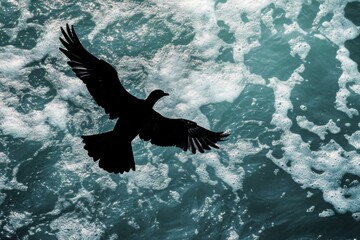 A striking silhouette of a bird soaring above vibrant turquoise ocean waves, capturing a moment of freedom and tranquility in nature's beauty.