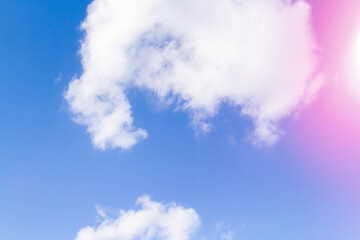 Obraz premium White airy beautiful clouds in a bright blue sky. Clear sunny weather. The concept of environmental safety and cleanliness..