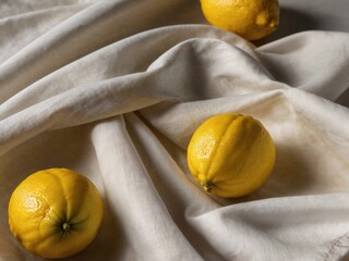Bright yellow fresh lemon on white fabric. Generative AI.