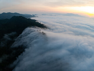 Drone aerial view of landscape fog over mountains in sunrise sky,High angle view over countryside at Southeast asia,Phang Nga Thailand,Wide angle view nature landscape
