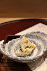 Japanese cuisine: renkon (lotus root) and dried persimmon with cream cheese in Tokyo, Japan