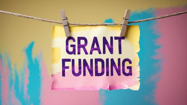 Concept of business and grant funding. Blank space. Words on paper hanging from a rope with a yellow background.