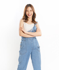 Fototapeta premium Portrait of smiling young Asian woman standing and looking at camera with arms crossed on a white background.