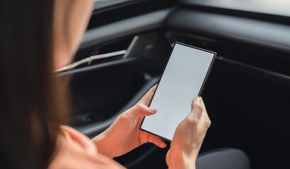 Woman sitting in a private car and hand holding smartphone mockup of blank screen, Take your screen to put on advertising