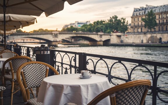 Seine River, Parisian cafe terrace at sunset with Seine River view