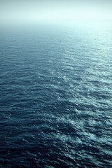 Obraz premium Calm ocean surface reflecting soft light at dawn with gentle waves creating a serene atmosphere