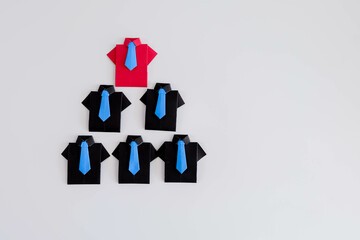 The origami is a red shirt and tie, representing a young businessman as the leader of the team.