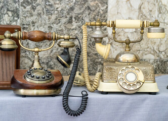 Old phones. A disk with numbers and letters, a tube on a wire. First prototype retro telephone