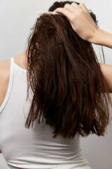 Fototapeta premium Hair care, styling, personal grooming, long hair, brown hair, white background, healthy hair, beauty routine, hair maintenance, woman, combing, self care, hair texture, hair health, daily routine