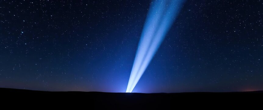 Piercing beam of light illuminates a star-studded night sky above a dark landscape, celestial,  dark night