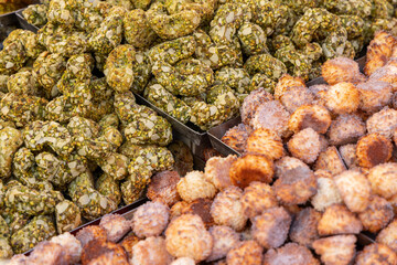 Traditional Italian almond and pistachio cookies with crunchy textures and nut coatings displayed...