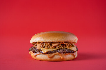 Sandwich two slices of grilled meat burger with melted cheese. 