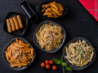 A set of dishes with different types of macaroni and cheese fingers.