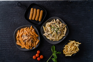 A set of dishes with different types of macaroni and cheese fingers.