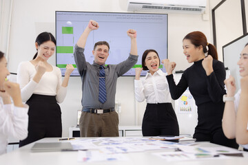 Happy excited business teamwork with marketing strategy analysis in meeting room at office, Business people working together in creative office, Business group celebrating in boardroom meeting.
