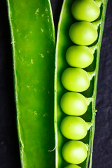 Macro shot of open green sugar snap pea pod. Green pea beans vegetables. Food photography