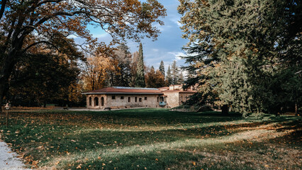 A truly picturesque autumn scene that features a charming rustic house surrounded by vibrant fall foliage all around